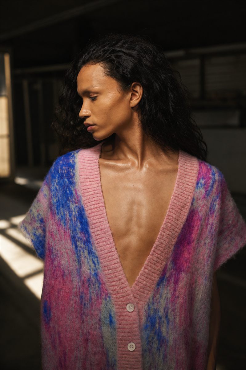 Model in a brushed mohair V-neck cardigan in pink, blue and magenta